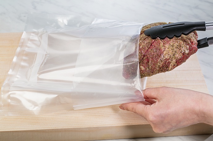 牛もも肉に調味料をすりこむ